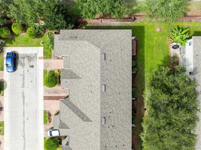 an aerial view of residential houses with yard