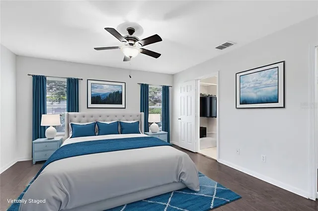 a bedroom with a large bed and a chandelier