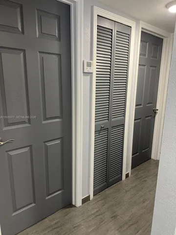 a bathroom with a toilet mirror vanity and window