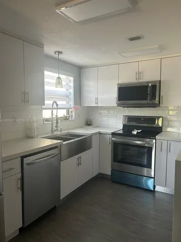a view of room with stairs and wooden floor