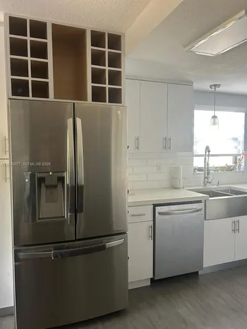 an empty room with wooden floor and window