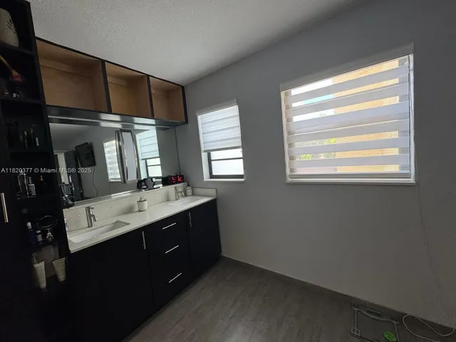 a kitchen with a sink cabinets and window