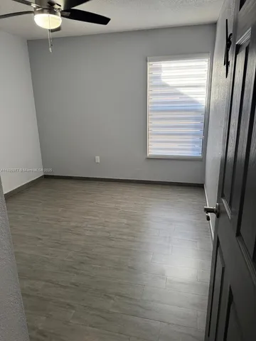 a view of a room with rack on the wall and a window