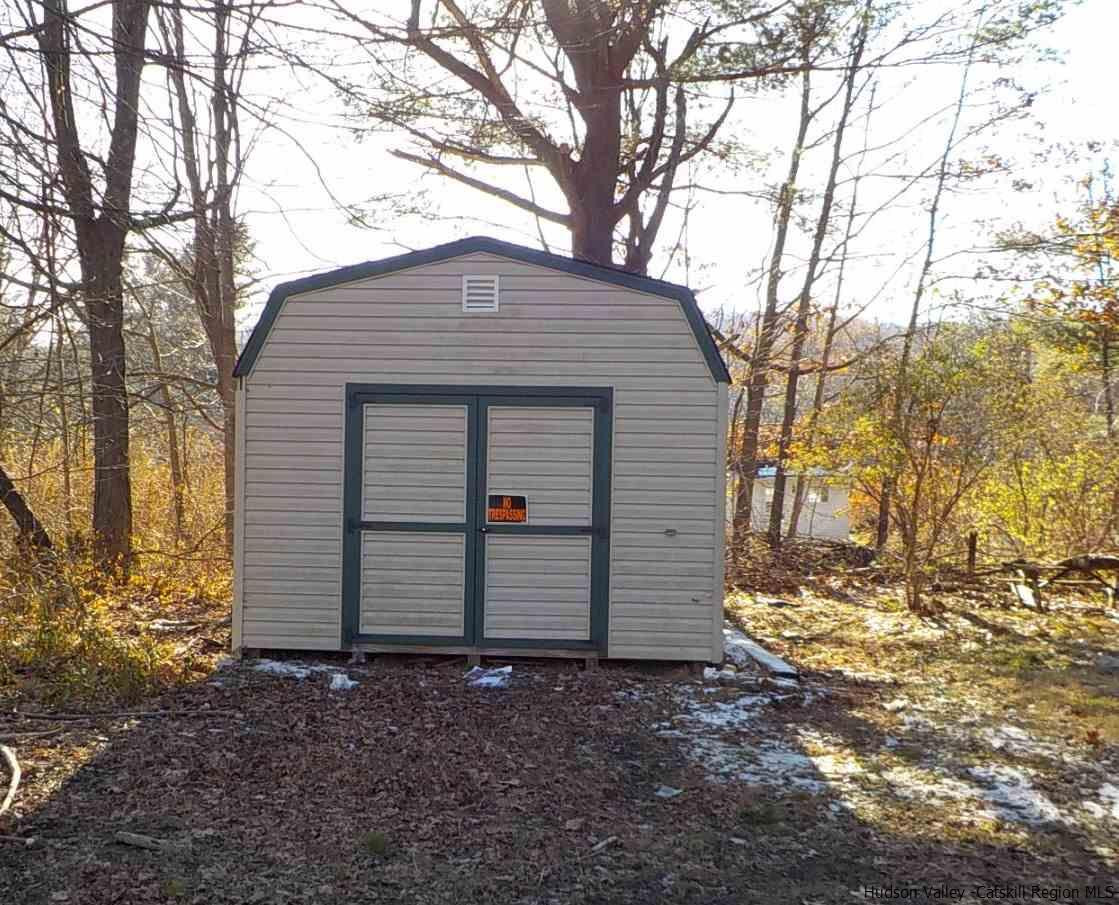 176 Beaver Road Red Hook, NY 12571 - Photo 10 of 12 a backyard of a house with a yard and garage