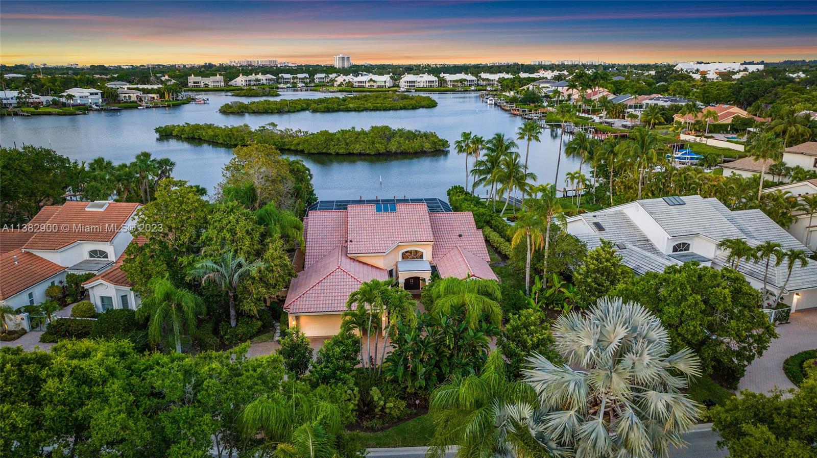 an aerial view of residential houses with outdoor space and lake view