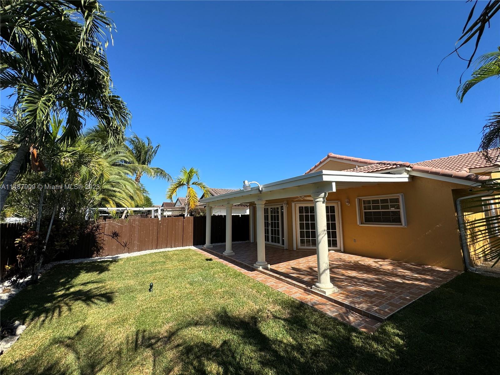 12913 Southwest 60th Street, Unit 12913 Miami, FL 33183 - Photo 4 of 17 a view of a house with a backyard