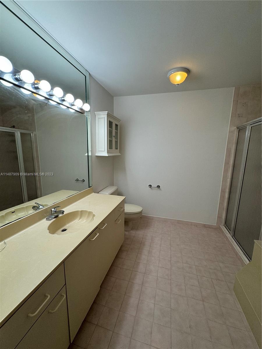 12913 Southwest 60th Street, Unit 12913 Miami, FL 33183 - Photo 8 of 17 a bathroom with a tub sink and mirror