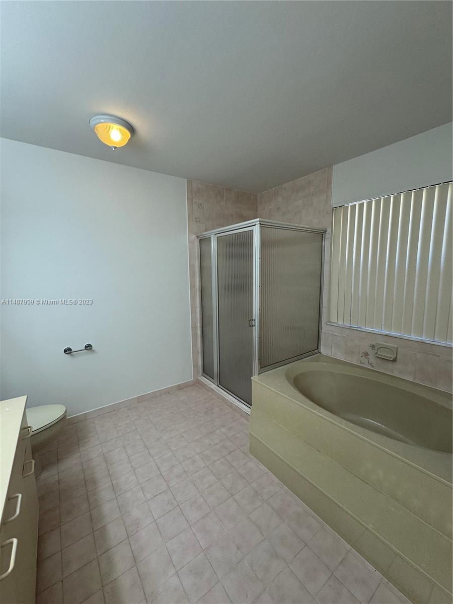 12913 Southwest 60th Street, Unit 12913 Miami, FL 33183 - Photo 9 of 17 a bathroom with a sink and a tub