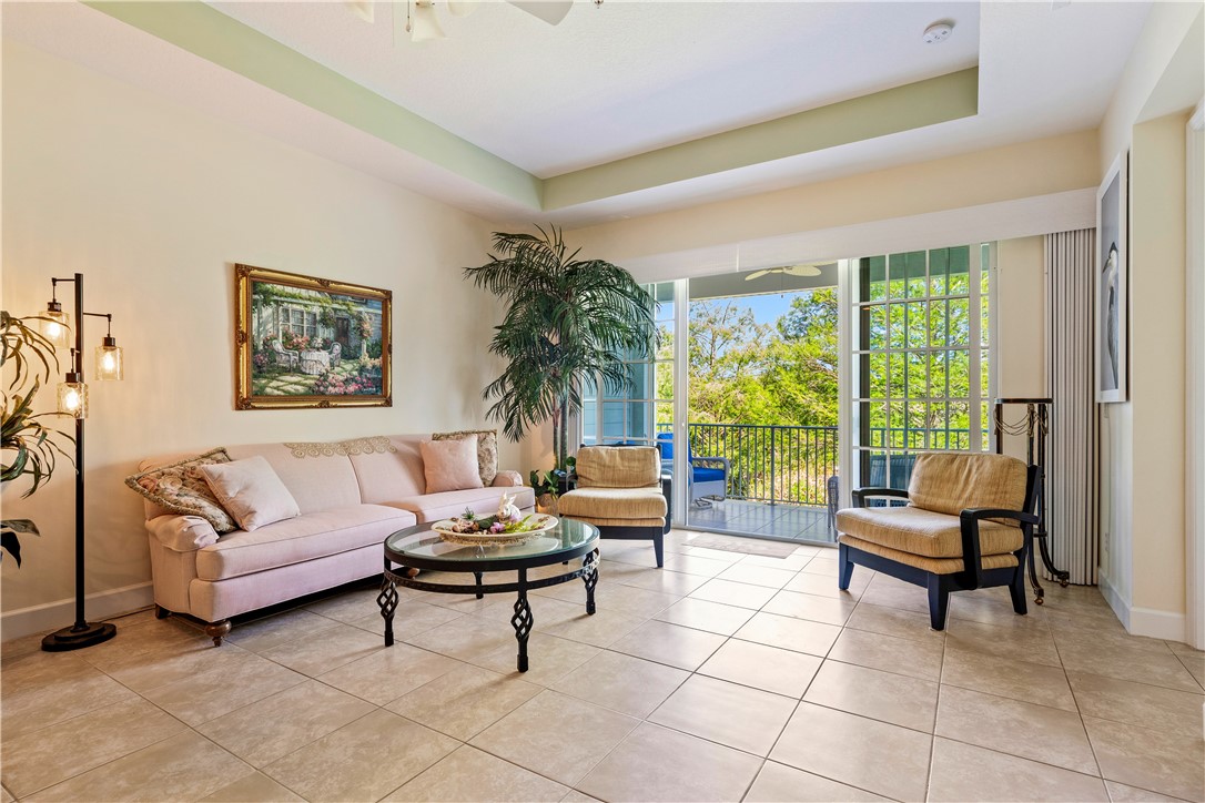 2340 Water Oak Court Southwest, Unit 223 Vero Beach, FL 32962 - Photo 14 of 36 a living room with furniture and a large window