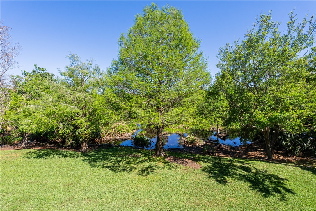 2340 Water Oak Court Southwest, Unit 223 Vero Beach, FL 32962 - Photo 18 of 36 a backyard of a house with lots of green space
