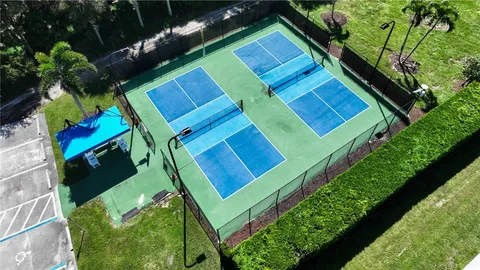 an aerial view of a house with a yard and lake view