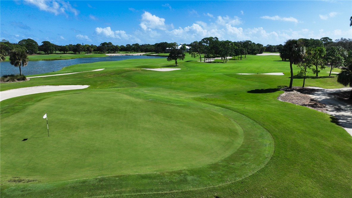 2340 Water Oak Court Southwest, Unit 223 Vero Beach, FL 32962 - Photo 35 of 36 a view of building with grass and a yard