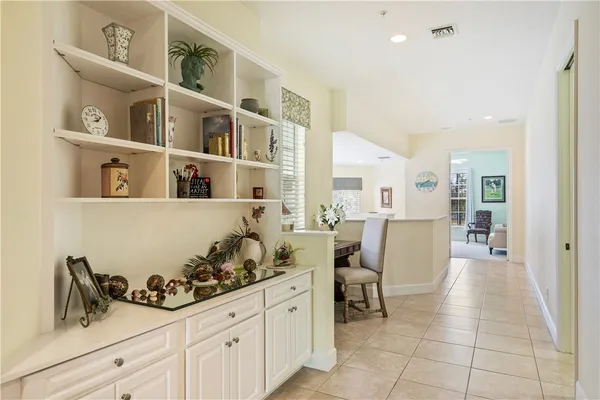 a living room with furniture and a book shelf