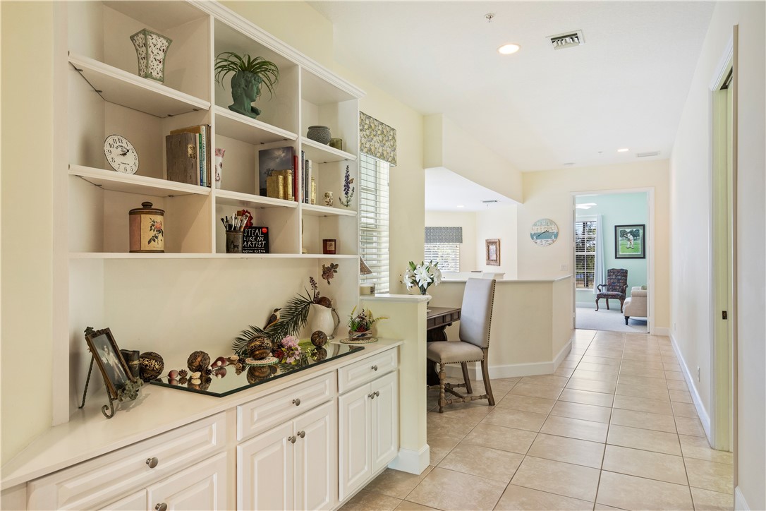 2340 Water Oak Court Southwest, Unit 223 Vero Beach, FL 32962 - Photo 5 of 36 a living room with furniture and a book shelf