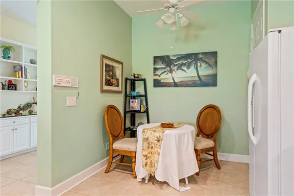 a kitchen with kitchen island granite countertop a stove and white cabinets with wooden floor