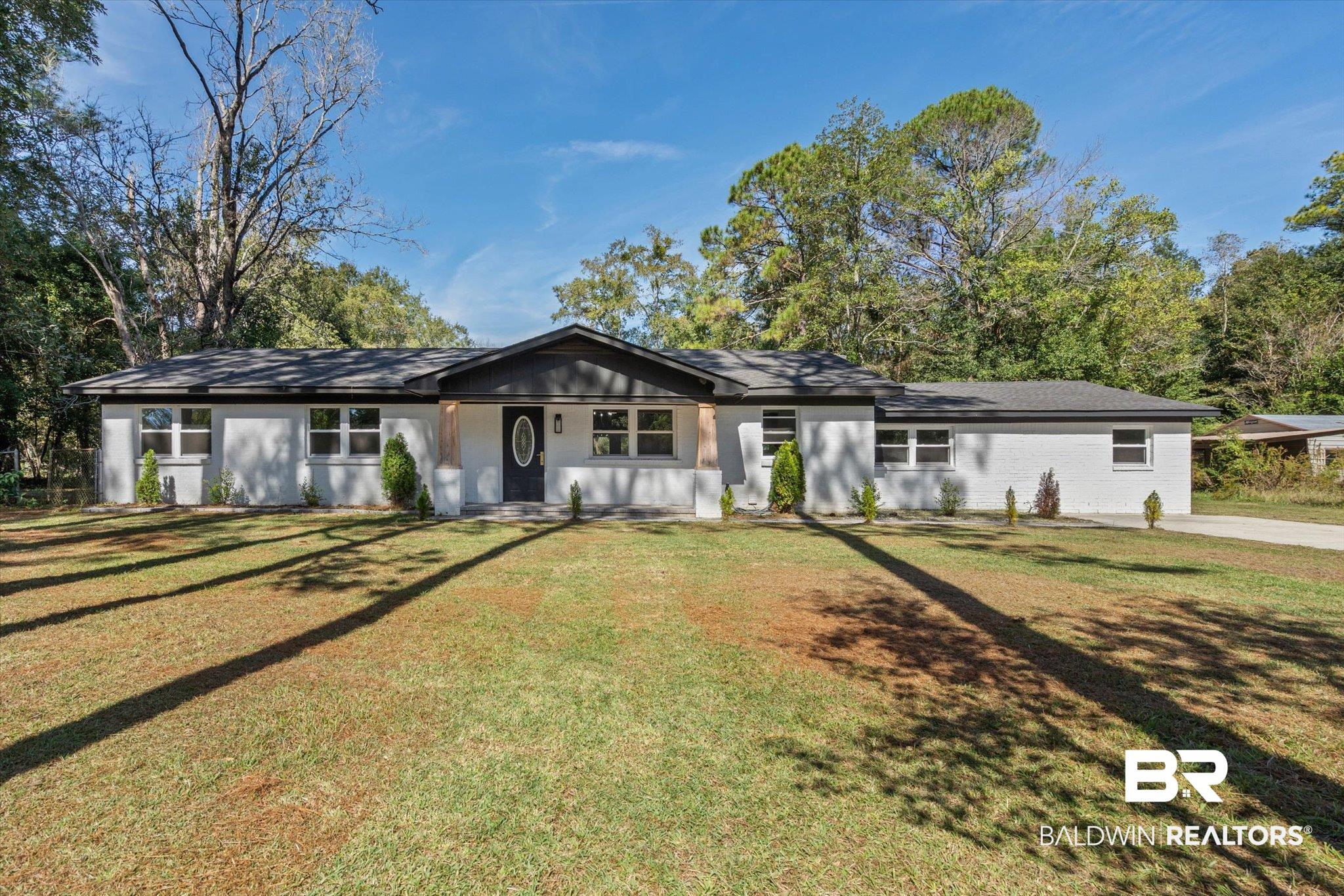 Ranch-style home featuring a front yard