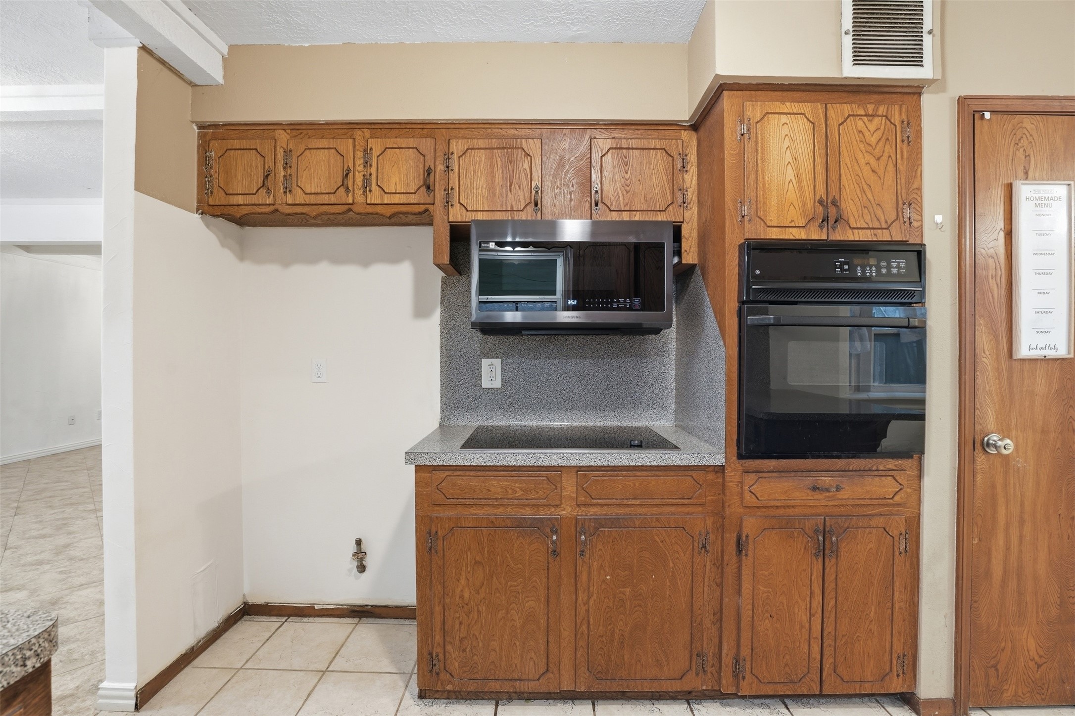 2605 Burke Road Pasadena, TX 77502 - Photo 7 of 29 a kitchen with stainless steel appliances a refrigerator and cabinets