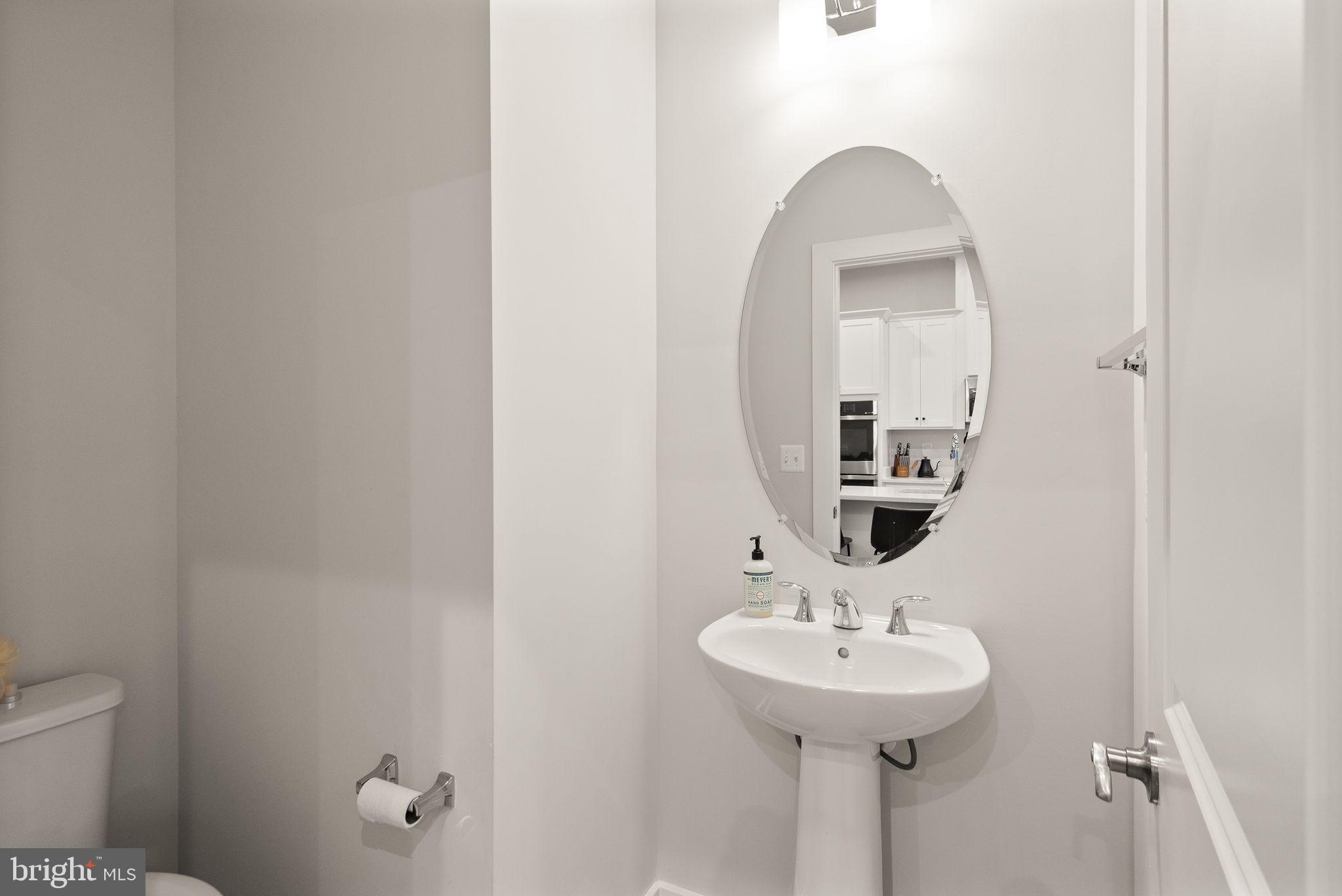 18353 Moss Garden Road Dumfries, VA 22026 - Photo 19 of 79 a bathroom with a sink and a mirror