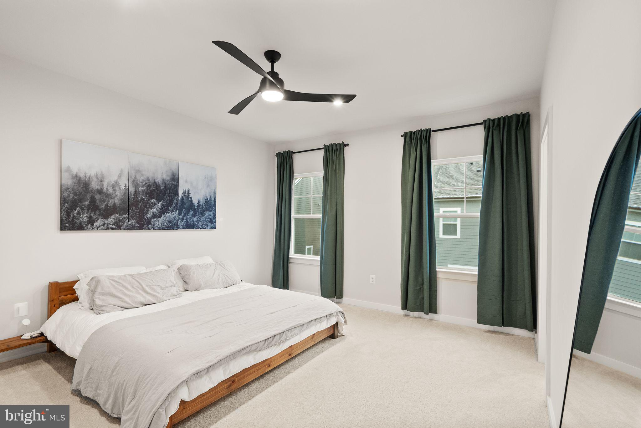 18353 Moss Garden Road Dumfries, VA 22026 - Photo 20 of 79 a bedroom with a large bed and a chandelier