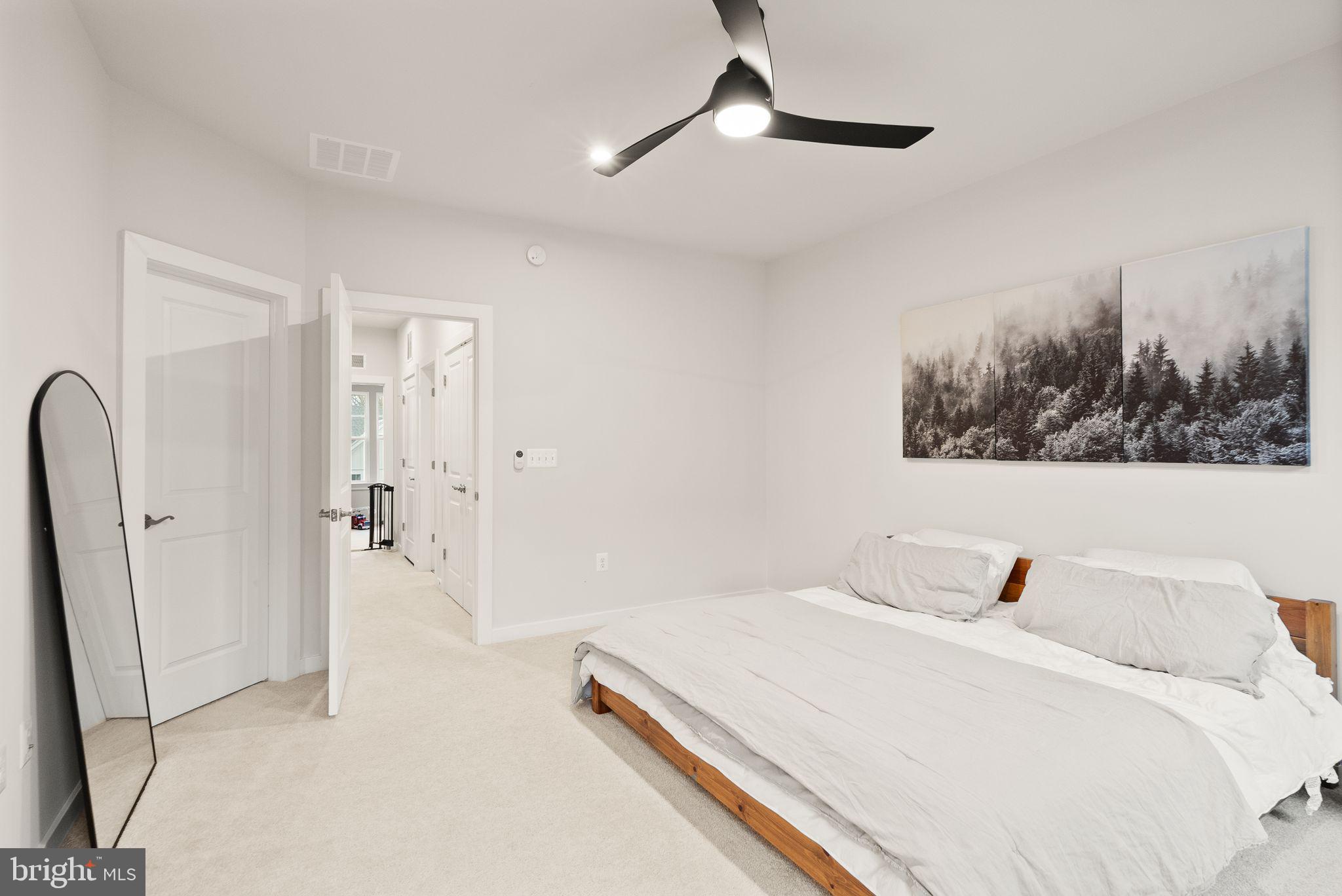 18353 Moss Garden Road Dumfries, VA 22026 - Photo 21 of 79 a bed room with a bed and a chandelier