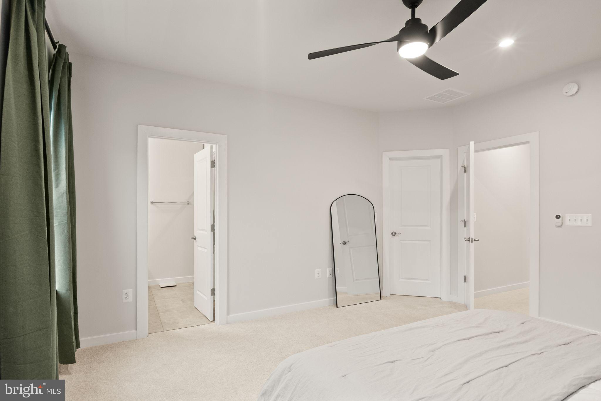 18353 Moss Garden Road Dumfries, VA 22026 - Photo 22 of 79 a bedroom with a bed and a chandelier