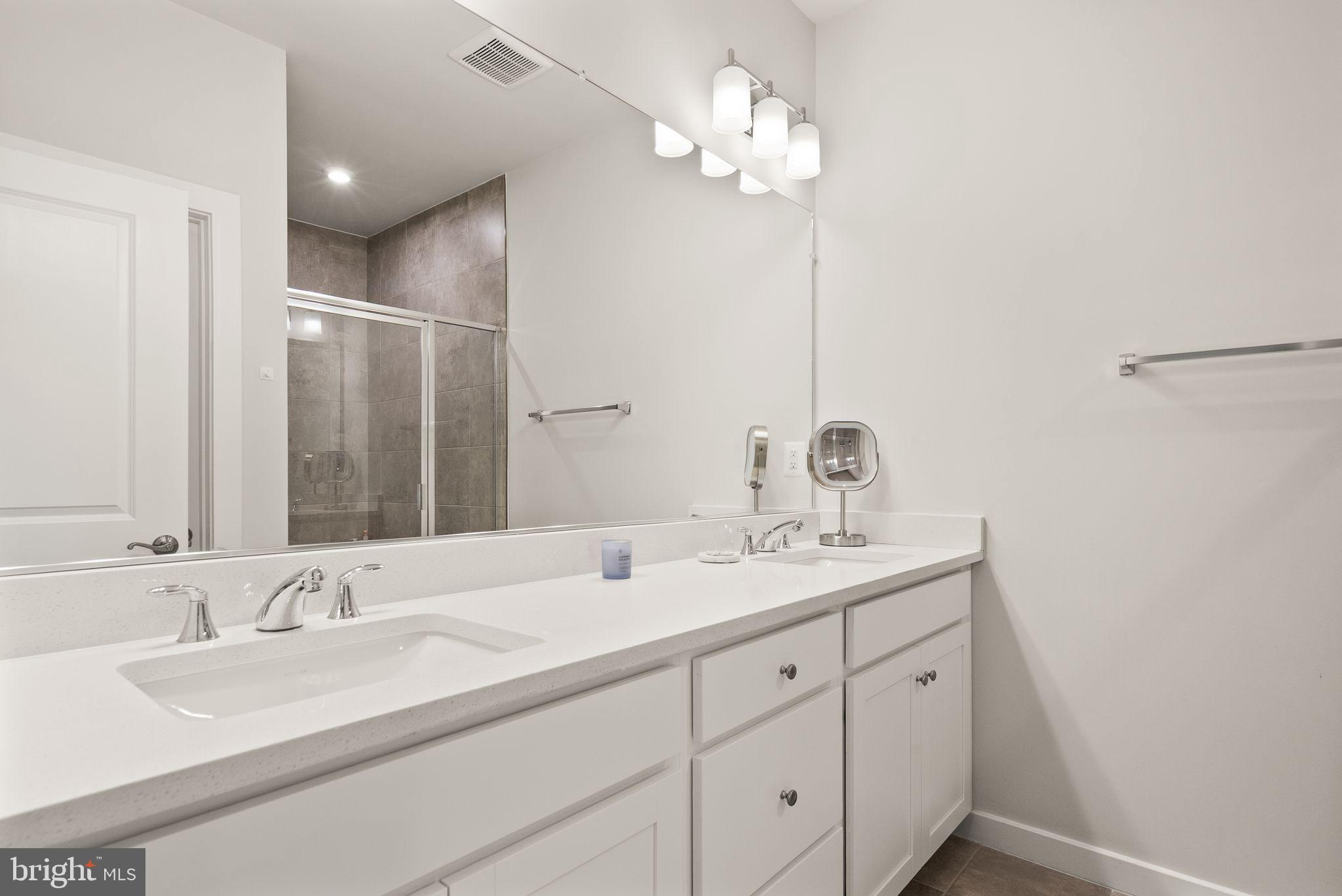 18353 Moss Garden Road Dumfries, VA 22026 - Photo 24 of 79 a bathroom with double sink and a mirror