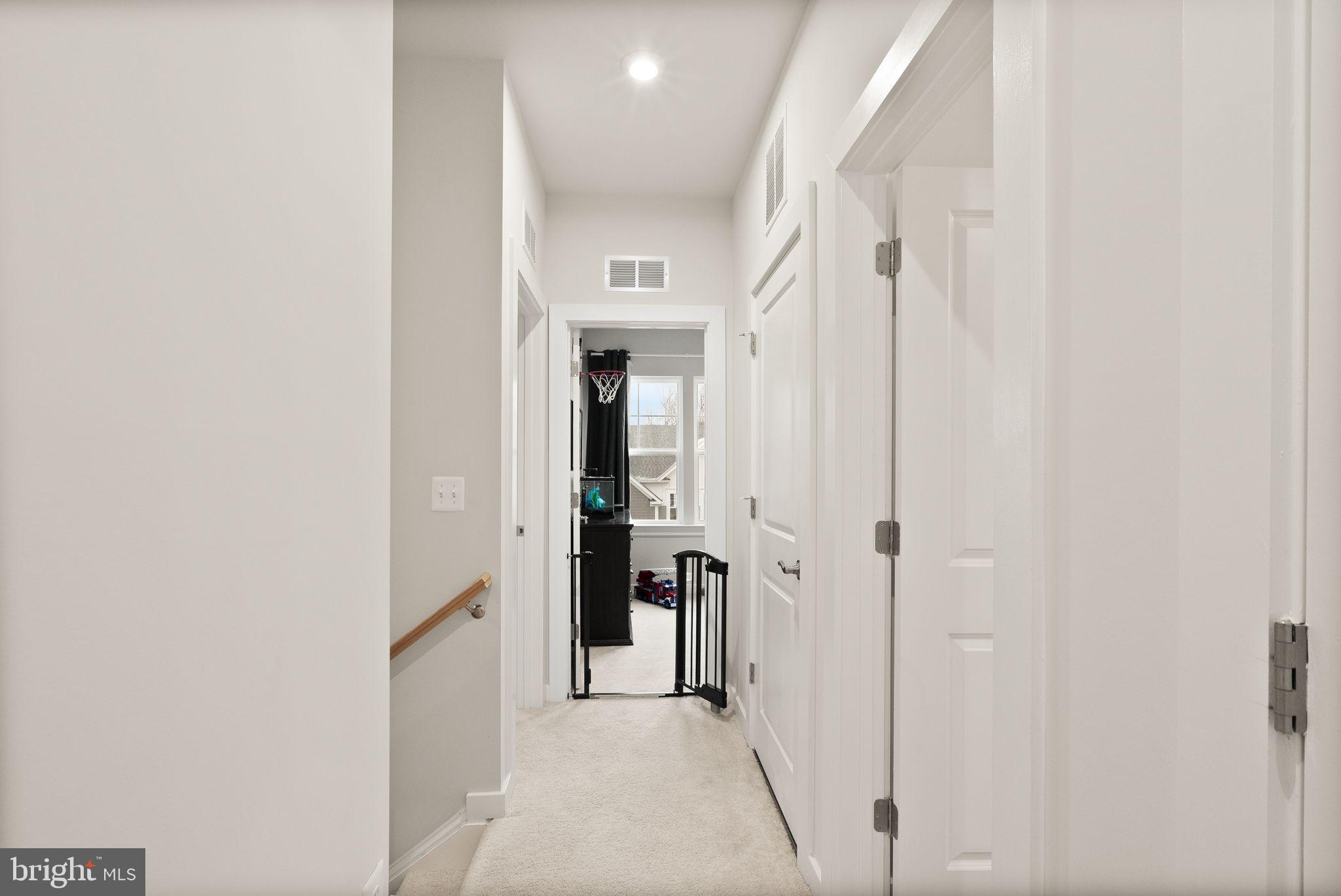 18353 Moss Garden Road Dumfries, VA 22026 - Photo 34 of 79 a view of a hallway with a white walls