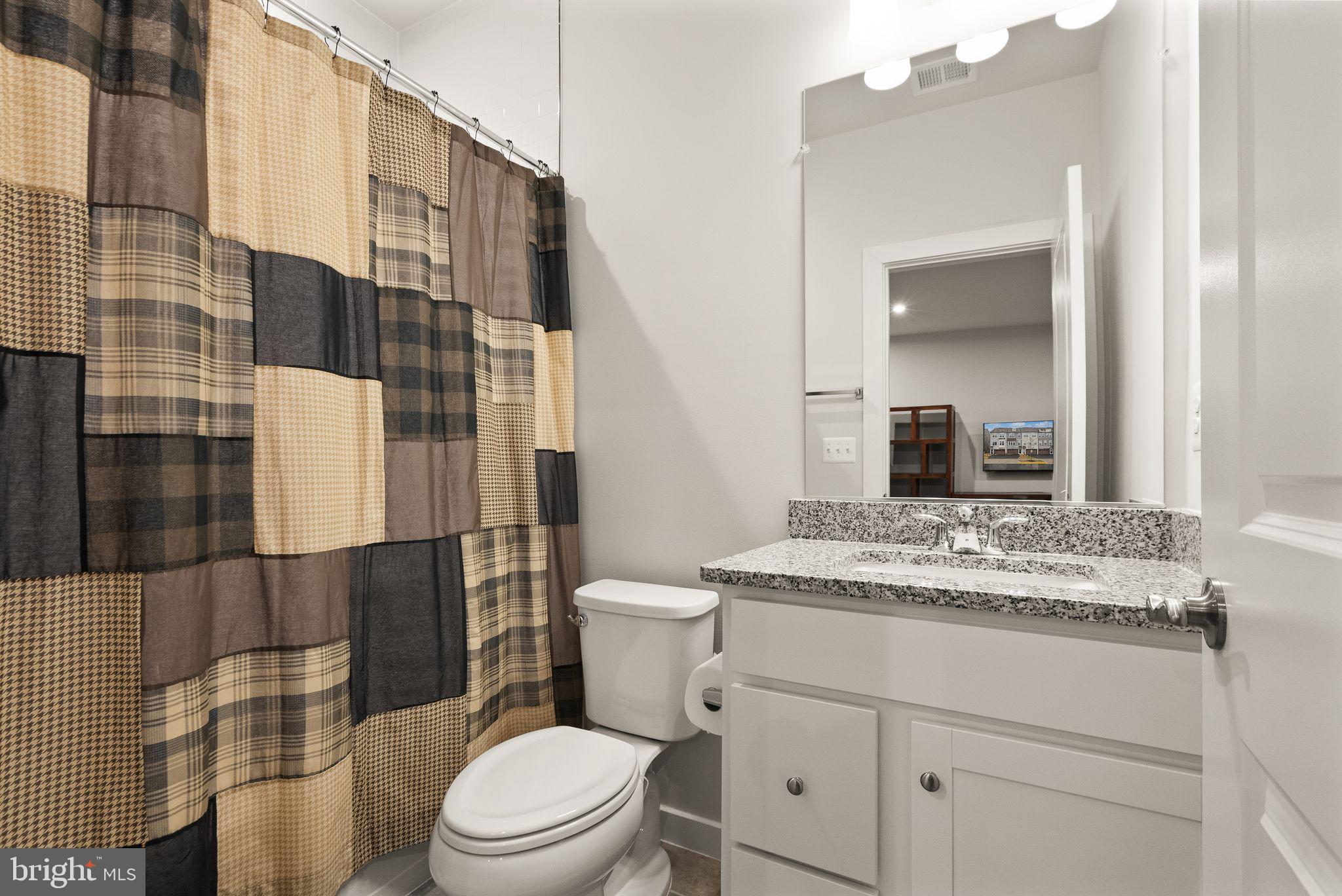 18353 Moss Garden Road Dumfries, VA 22026 - Photo 39 of 79 a bathroom with a granite countertop toilet sink and mirror