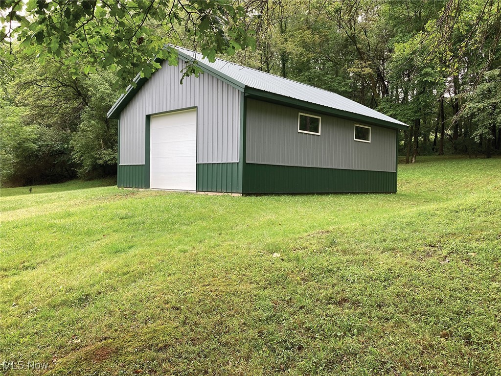 31386 Haessly Road Hanoverton, OH 44423 - Photo 2 of 8 View of outbuilding with a lawn and a garage