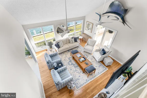 a bathroom with a toilet a sink a vanity a mirror and a window