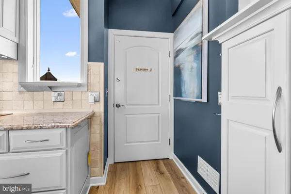 a bedroom with a bed and a wooden floor