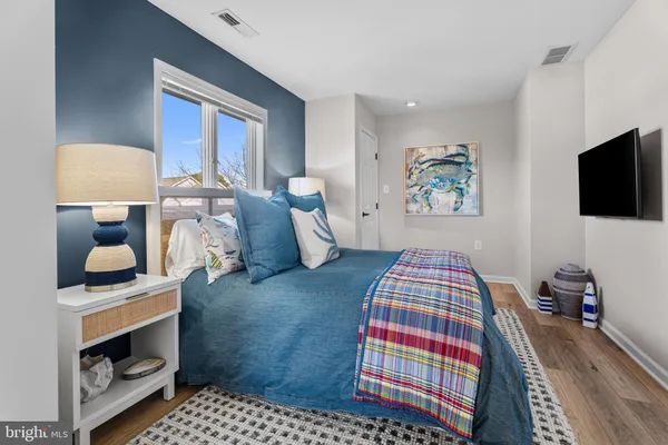 a large bedroom with a bed and a flat screen tv