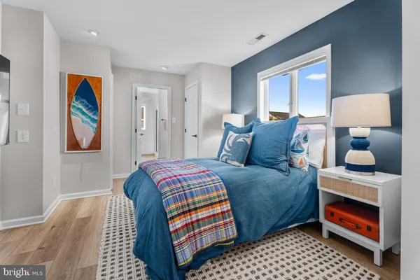 a spacious bedroom with a bed and glass door