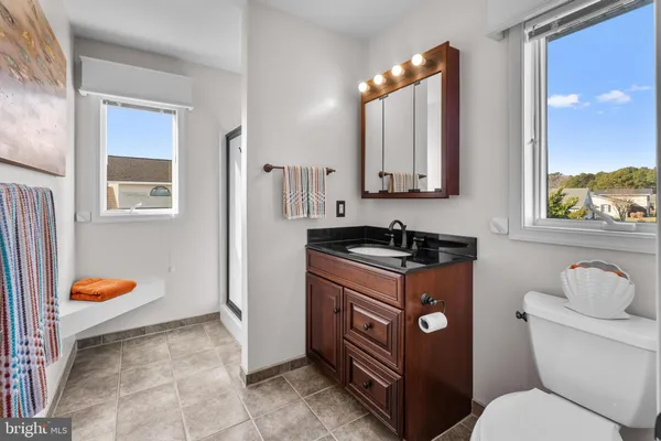 a bathroom with a sink vanity and a mirror