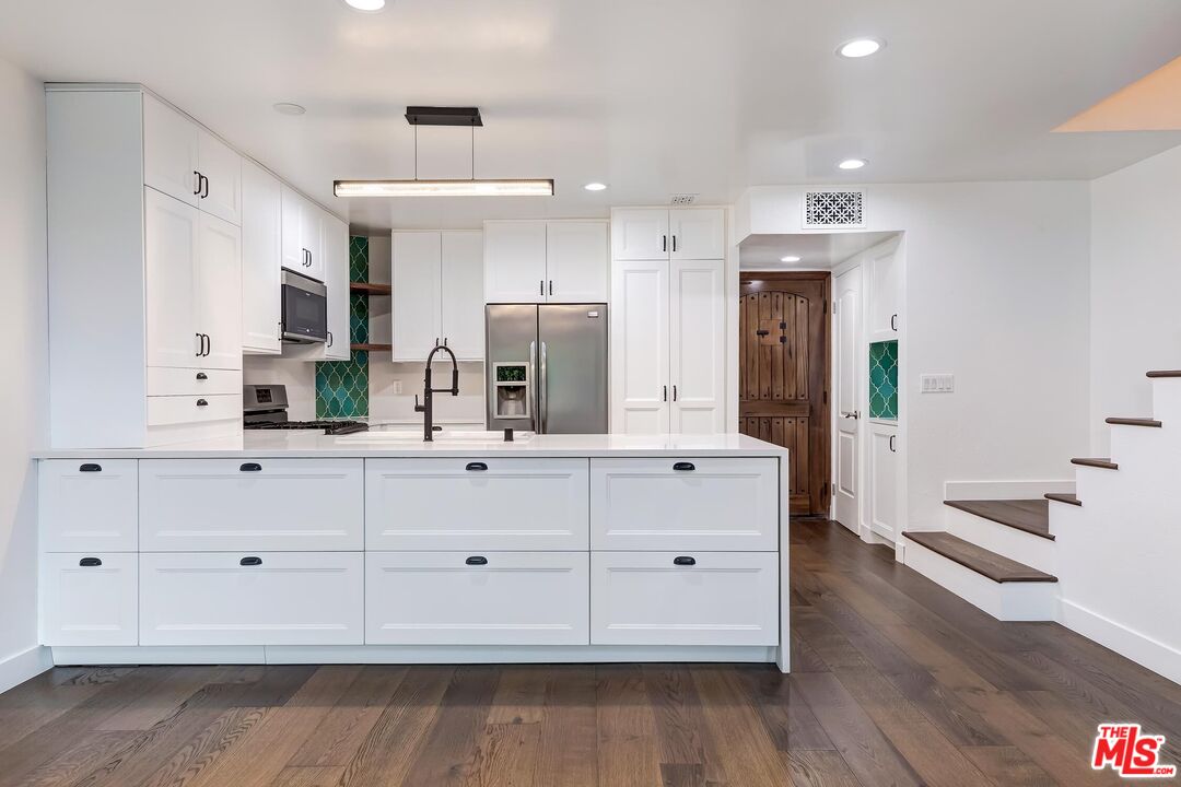 a bathroom with a double vanity sink and mirror
