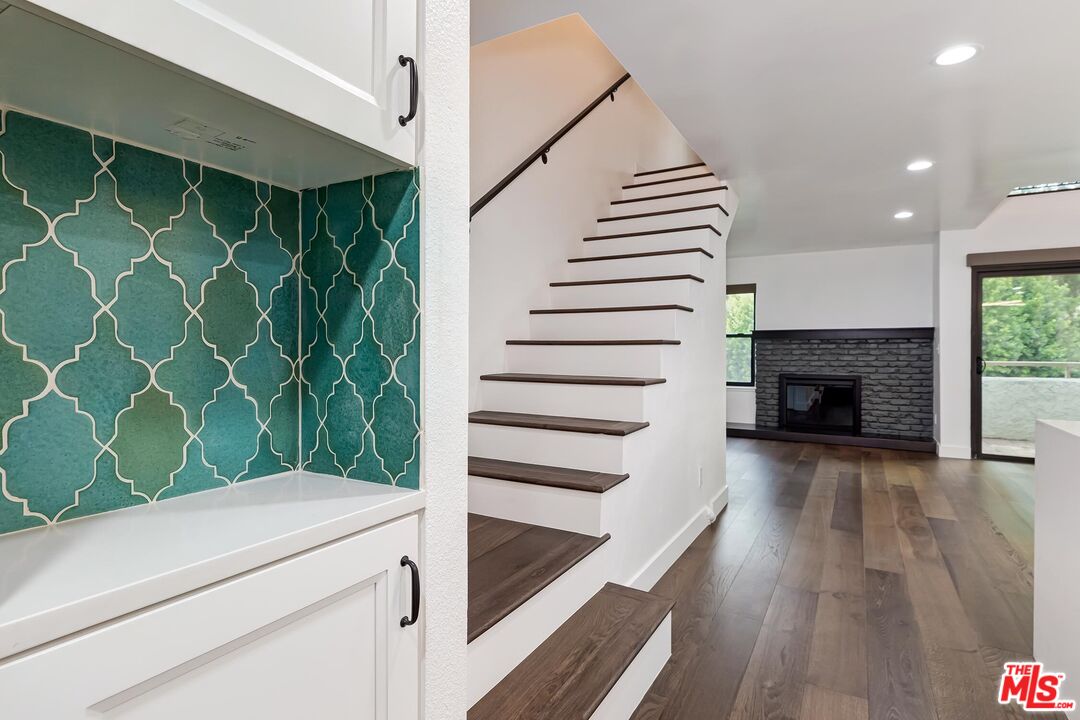 10926 Bluffside Drive, Unit 20 Studio City, CA 91604 - Photo 12 of 31 a view of a livingroom with wooden floor and a fireplace