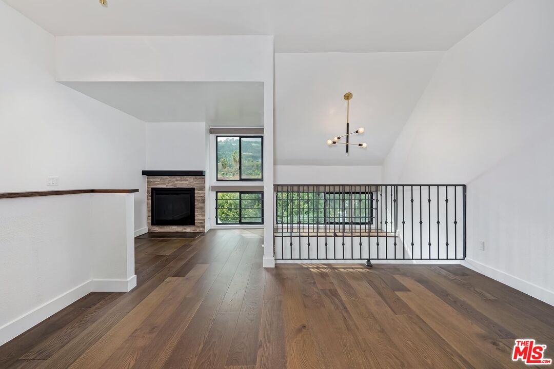 10926 Bluffside Drive, Unit 20 Studio City, CA 91604 - Photo 15 of 31 a view of a livingroom with wooden floor a fireplace