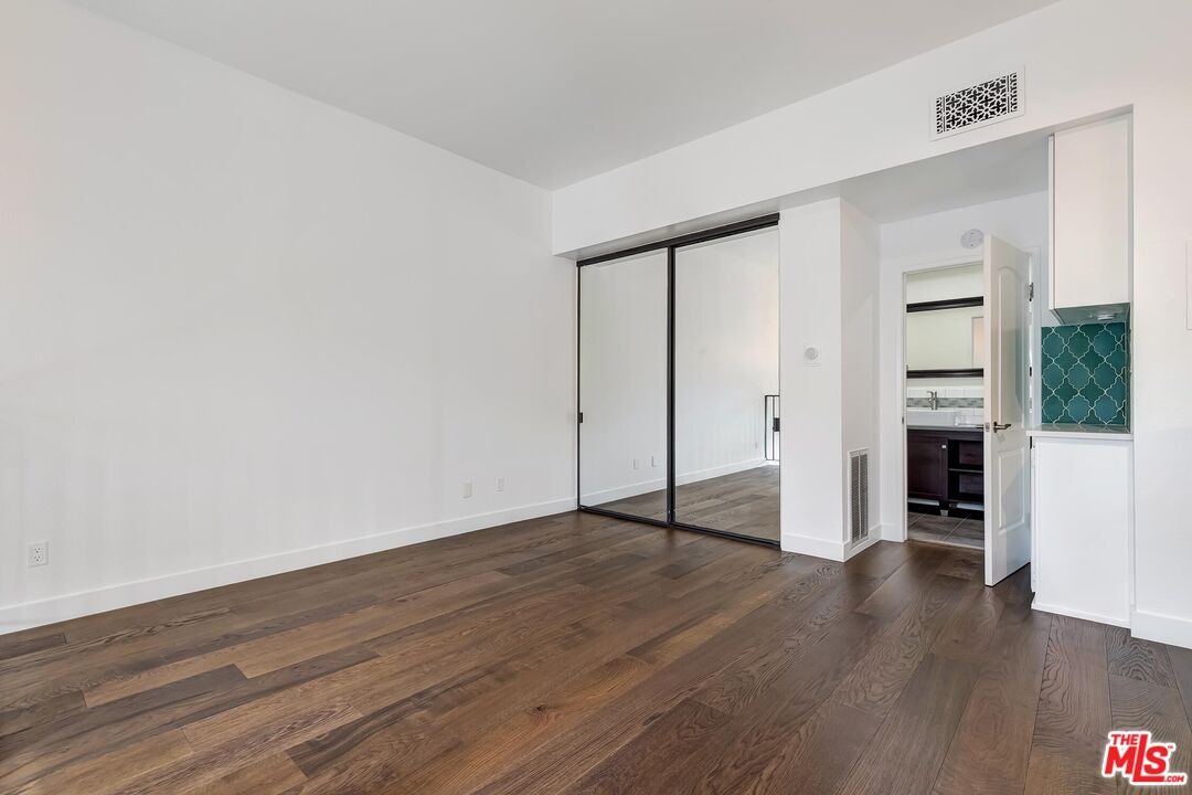 10926 Bluffside Drive, Unit 20 Studio City, CA 91604 - Photo 18 of 31 a view of an empty room with wooden floor