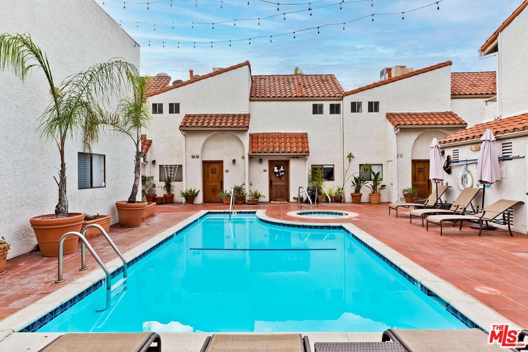 10926 Bluffside Drive, Unit 20 Studio City, CA 91604 - Photo 26 of 31 a view of a patio with swimming pool table and chairs