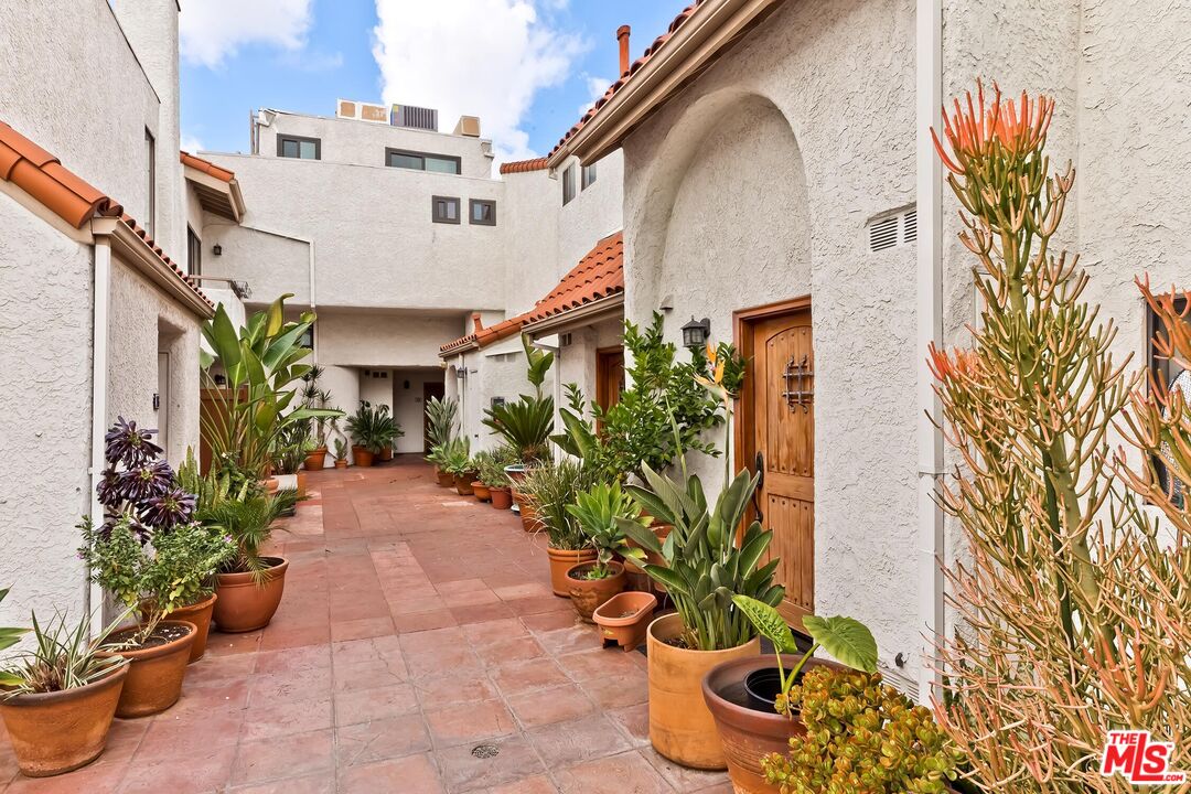 10926 Bluffside Drive, Unit 20 Studio City, CA 91604 - Photo 29 of 31 a front view of a house with a garden