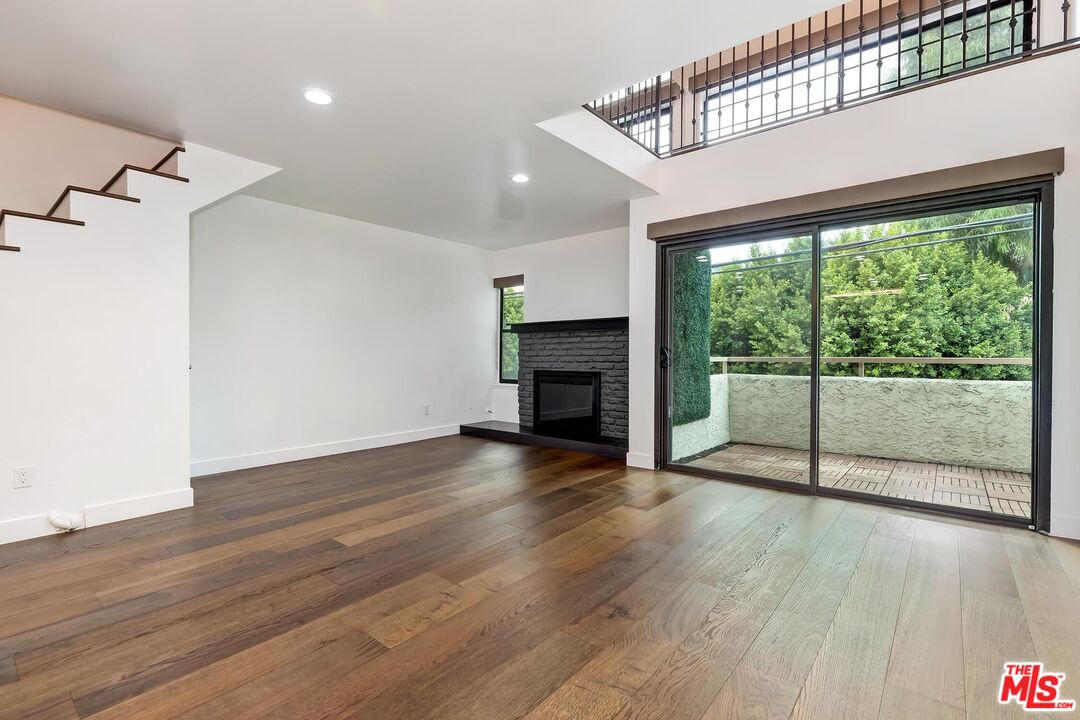 10926 Bluffside Drive, Unit 20 Studio City, CA 91604 - Photo 3 of 31 a view of a room with wooden floor and a fireplace