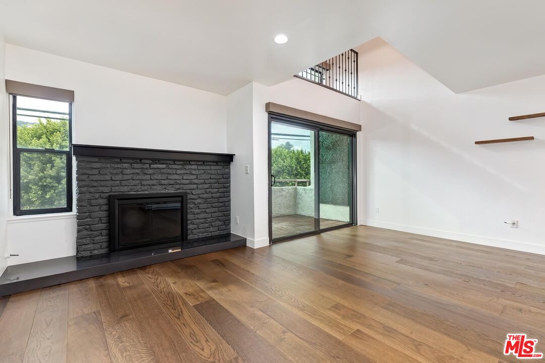 10926 Bluffside Drive, Unit 20 Studio City, CA 91604 - Photo 4 of 31 a view of an empty room with a fireplace and a window