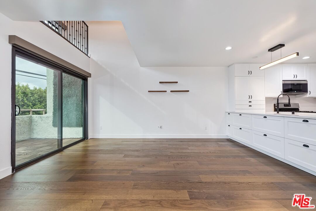 10926 Bluffside Drive, Unit 20 Studio City, CA 91604 - Photo 5 of 31 a view of empty room with wooden floor and fan