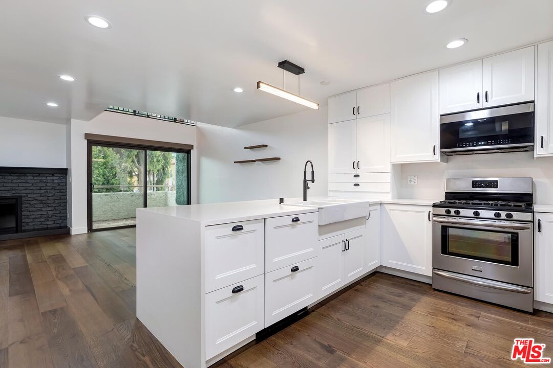 10926 Bluffside Drive, Unit 20 Studio City, CA 91604 - Photo 9 of 31 a kitchen with granite countertop a sink and steel appliances