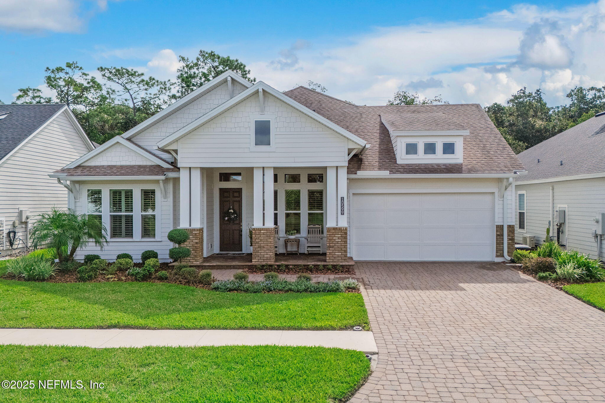 a front view of a house with a yard and porch