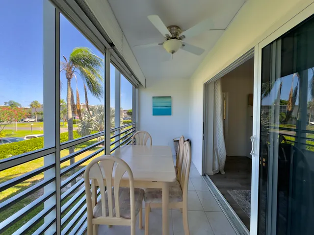 a view of a hallway with furniture and a floor to ceiling window