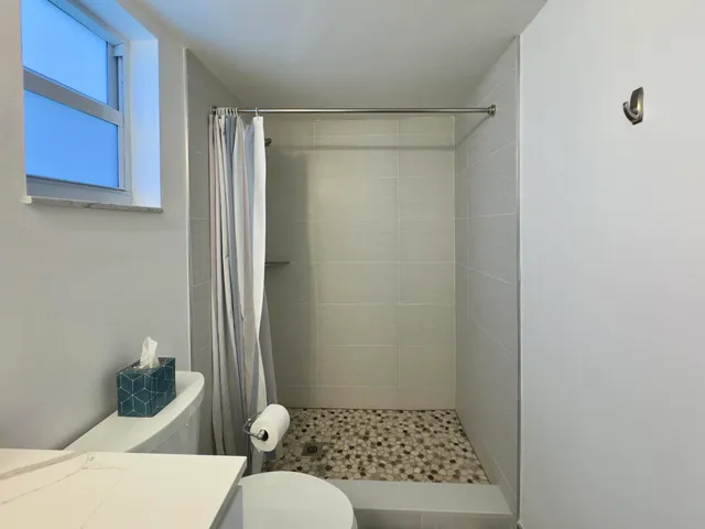 a bathroom with a toilet and shower