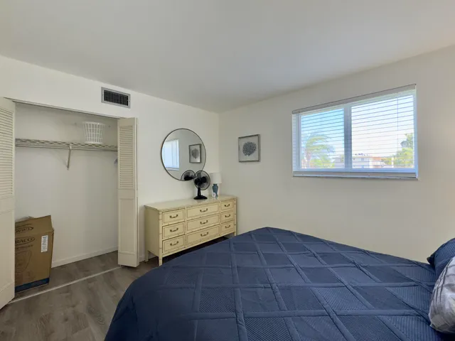 a room with a bed and a dresser