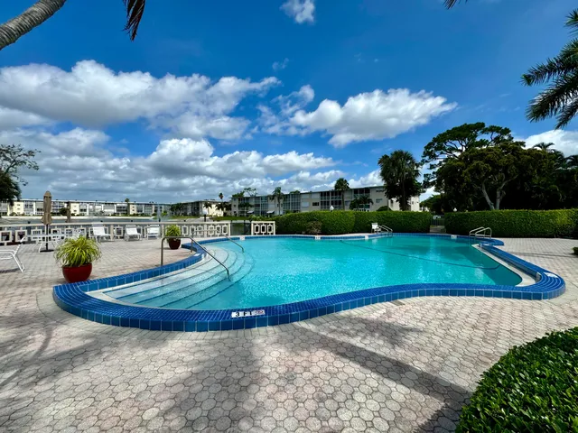 a view of a swimming pool with a yard