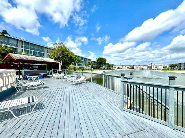 a view of a swimming pool with seating space